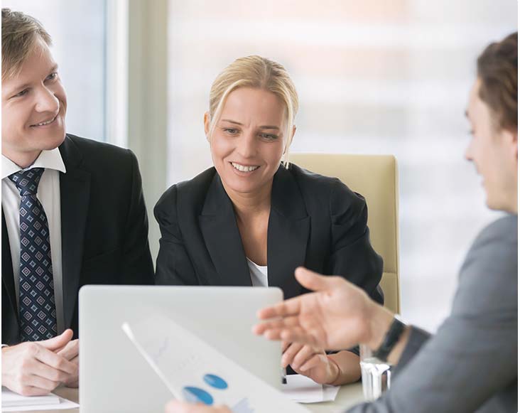 Three businesspeople discussing increasing sales statistics stock image